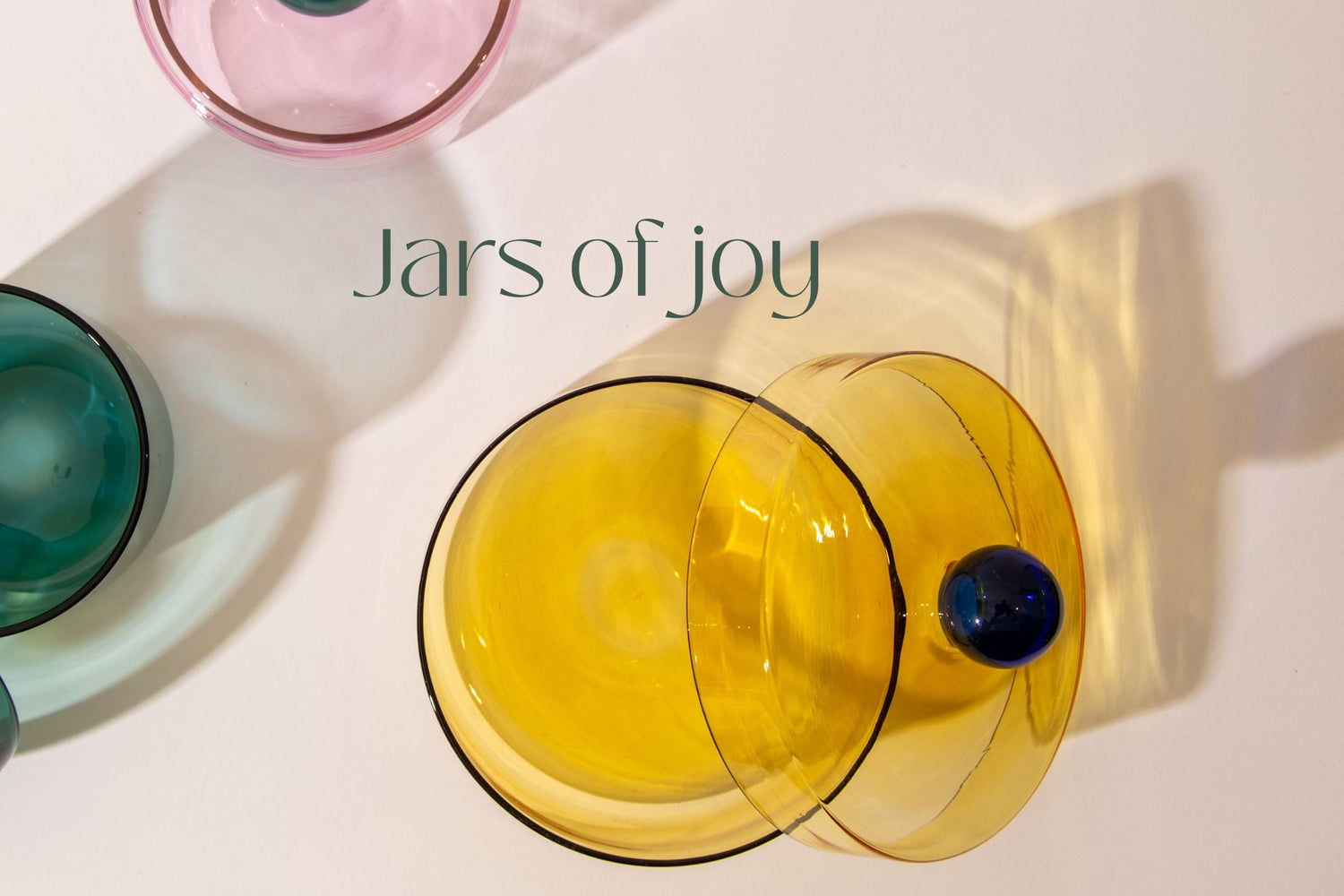 Two colorful glass jars with 'Jars of Joy' text on a light background